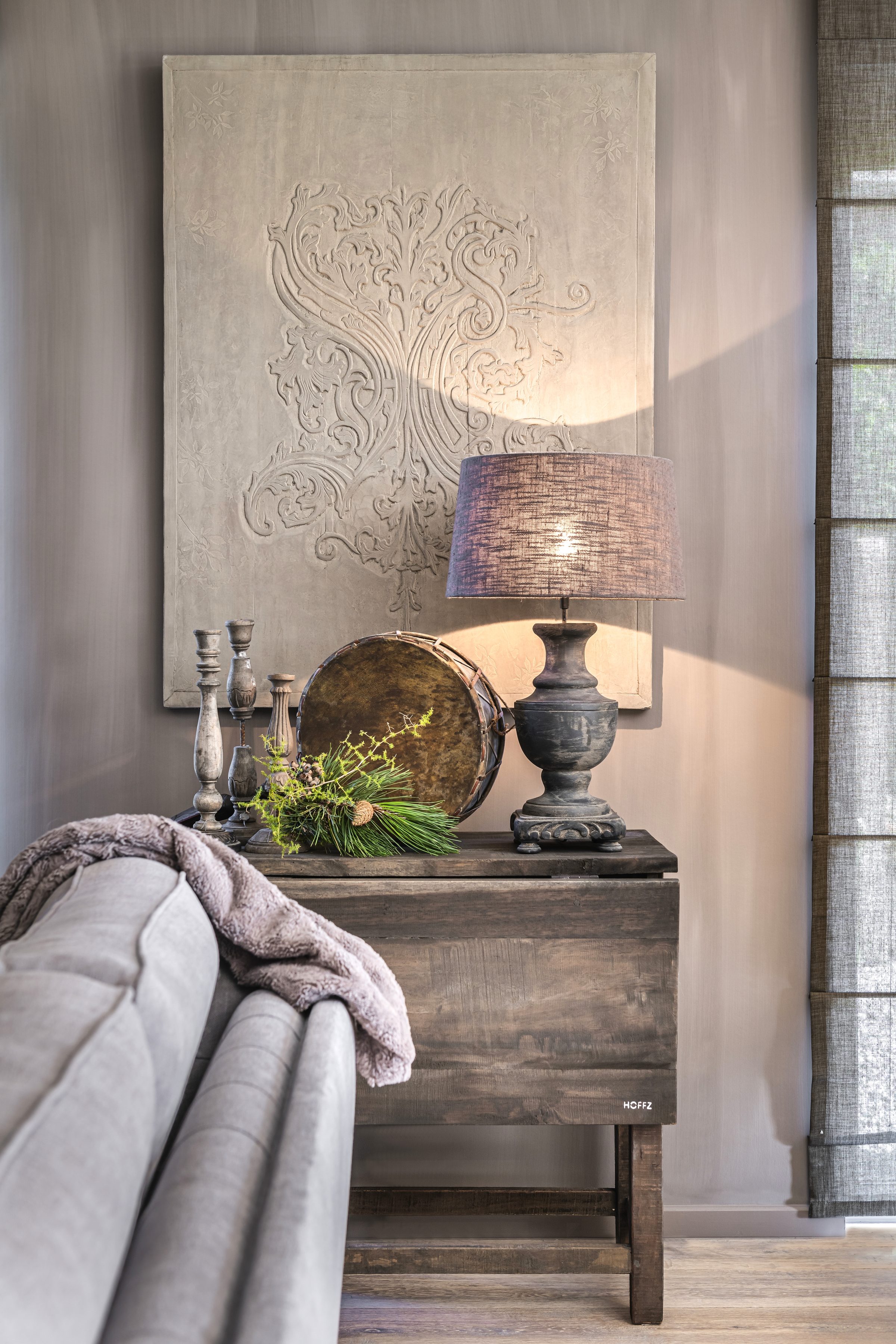 Sidetable in oud hout met linnen lamp en gesculpteerd wandpaneel