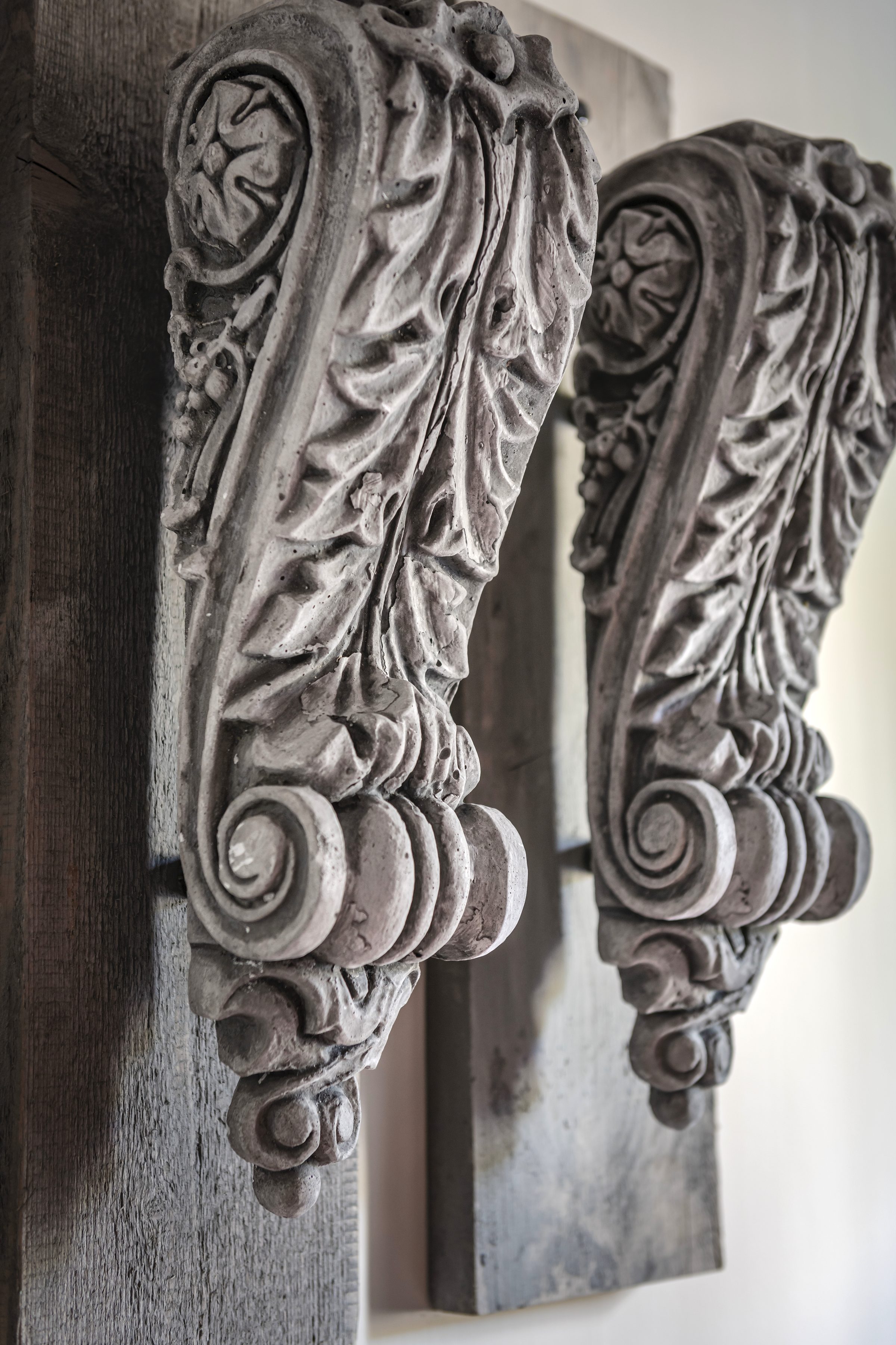 Stenen wandornamenten op verweerd hout, close-up van textuur